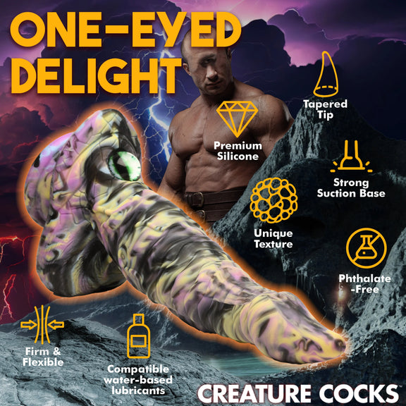 The Creature Cocks Cyclops surrounded by a list of icons and feature text. Text includes: Tapered tip, premium silicone, unique texture, strong suction base, phthalate-free, compatible with water-based lubricants, Firm and flexible | Kinkly Shop