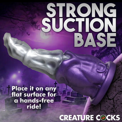 The Creature Cocks Grim Reaper shown suction cupped to a cracked rock. Text reads "Strong suction base.Place it on any flat surface for a hands-free ride!" | Kinkly Shop