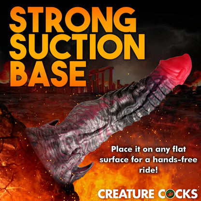 The Creature Cocks Hades shown photoshopped suctioned onto the side of a volcano. Text reads: "Strong suction base. Place it on any flat surface for a hands-free ride" | Kinkly Shop