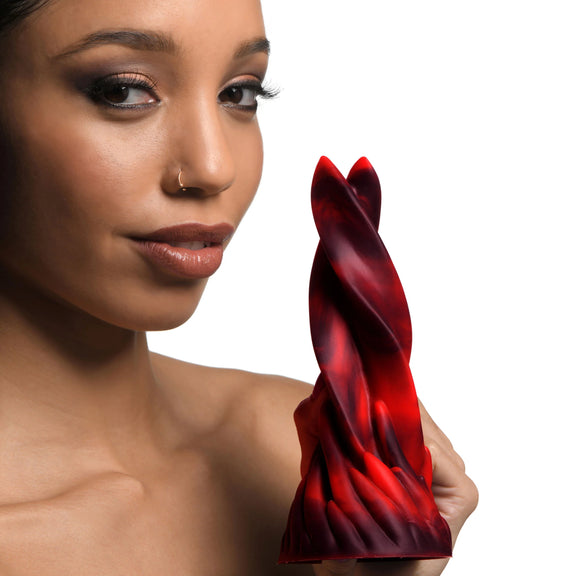 A person holds the Creature Cocks Hell Kiss in front of a camera. The dildo looks thick but not particularly long. | Kinkly Shop