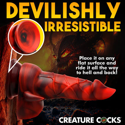 The Creature Cocks Horny Devil shown suction cupped up to a volcanic wall. Text on the image reads: "Devilish irresistible. Place it on any flat surface and ride it all the way to hell and back."  | Kinkly Shop