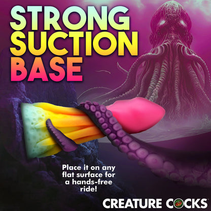 The Creature Cocks King Kraken shown stuck onto a rock. Text reads: "Strong suction cup base. Place it on any flat surface for hands-free rides" | Kinkly Shop
