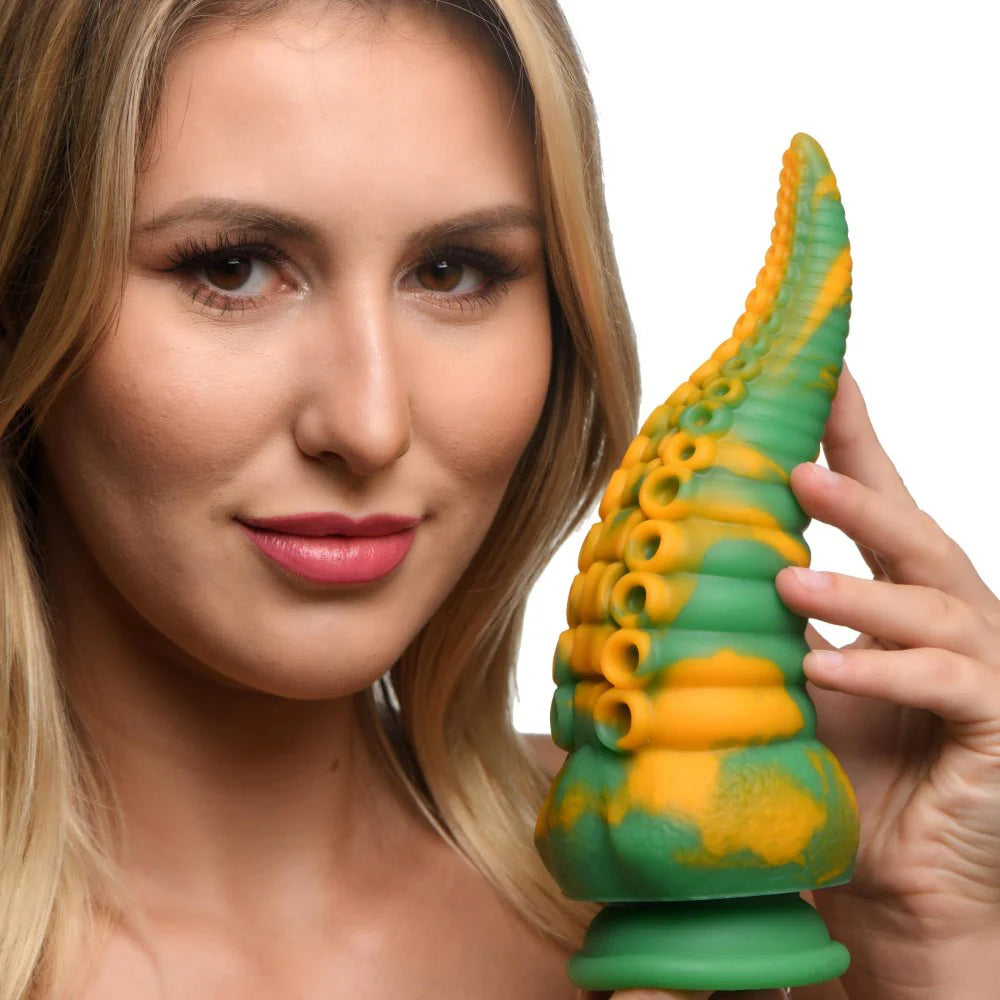 A person is holding the Creature Cocks Monstropus in front of their face. The dildo looks about as long as their face and about as thick as half of their face. | Kinkly Shop