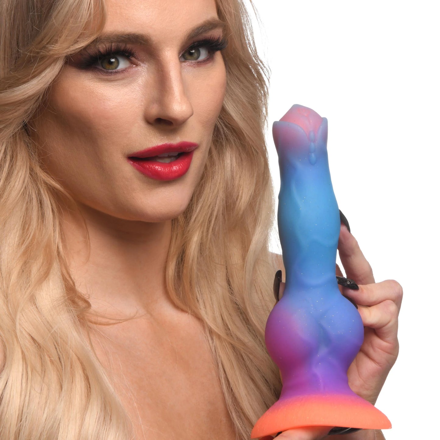 A person holds the Creature Cocks Space Cock, looking into the camera. The dildo is taller than their head. | Kinkly Shop