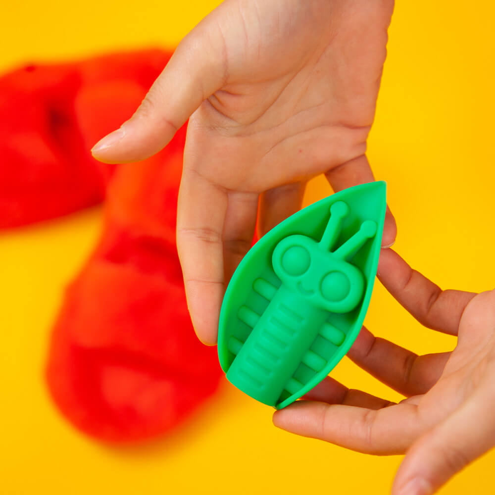 Two  hands cradle the Cute Little Fuckers Zeep. The vibrator looks small and tall in-between their fingers. It's about the length of the person's finger. | Kinkly Shop