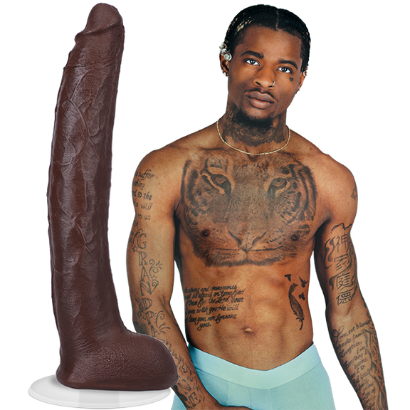 A shirtless Damion Dayski wearing boxer briefs. Their Signature Cocks - Damion Dayski dildo is shown next to the porn star. The dildo is lifecast from the model themselves. | Kinkly Shop