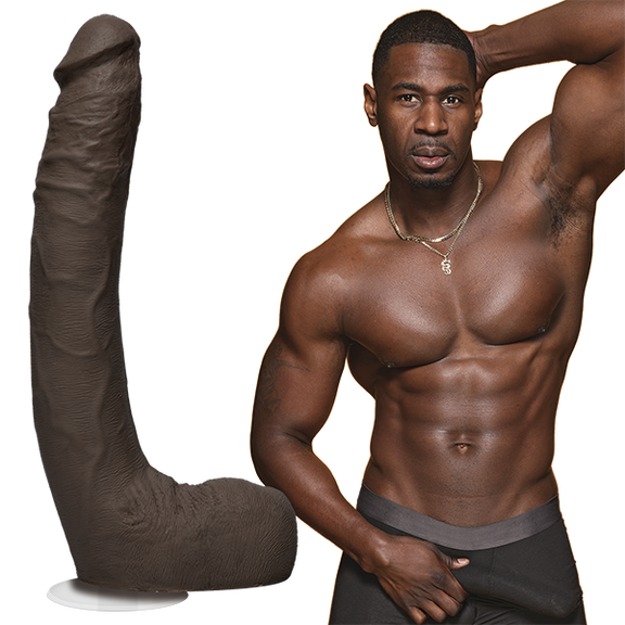 A shirtless Jax Slayher stares into the camera while grabbing the bulge in his boxer briefs. The Signature Cocks - Jax Slayher dildo is shown next to the porn star's body. | Kinkly Shop