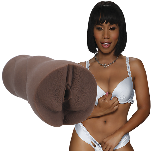 Jenna Foxx is wearing white lingerie and staring into the camera. The Signature Strokers Jenna Foxx stroker is shown next to the porn star. | Kinkly Shop