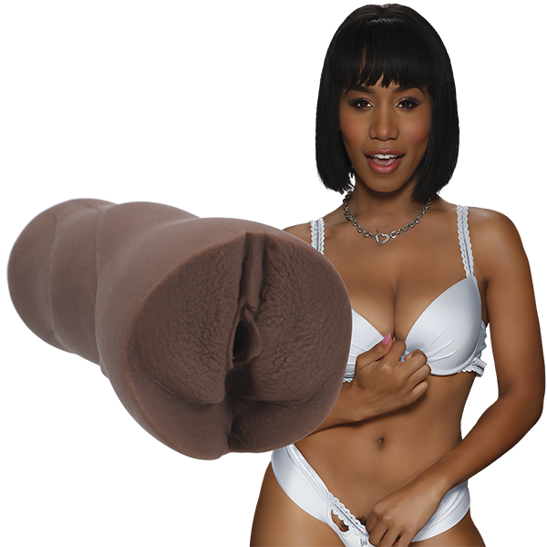Jenna Foxx is wearing white lingerie and staring into the camera. The Signature Strokers Jenna Foxx stroker is shown next to the porn star. | Kinkly Shop