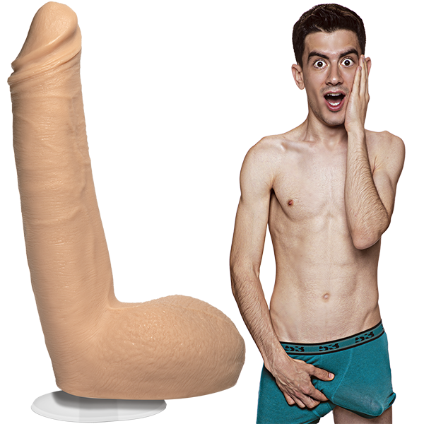 A shirtless Jordi El Nina Polla is wearing his boxer briefs with an erection. The Signature Cocks - Jordi El Nina Polla dildo is sitting out next to him, showcasing the lifecast dildo. | Kinkly Shop