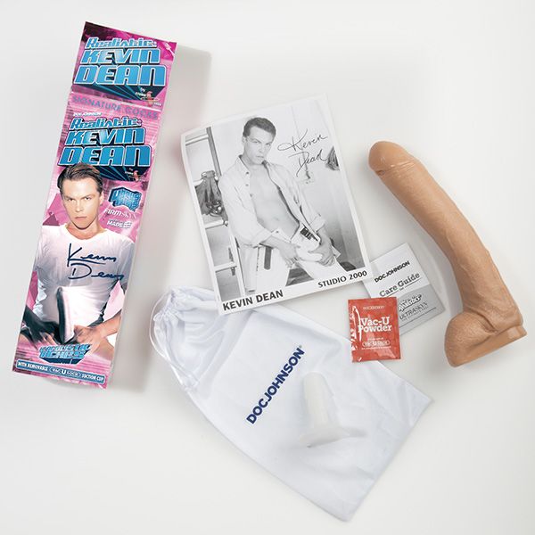 Everything that comes with the Signature Cocks Kevin Dean Firmskyn dildo. There's the dildo, the Care Guide, the drawstring storage bag, a sample of dildo care powder, and an autographed photo. | Kinkly Shop