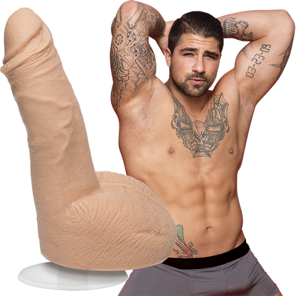 A shirtless Ryan Bones looks into the camera while wearing boxer briefs. The Signature Cocks - Ryan Bones dildo lifecast from the porn star is shown next to the porn star. | Kinkly Shop