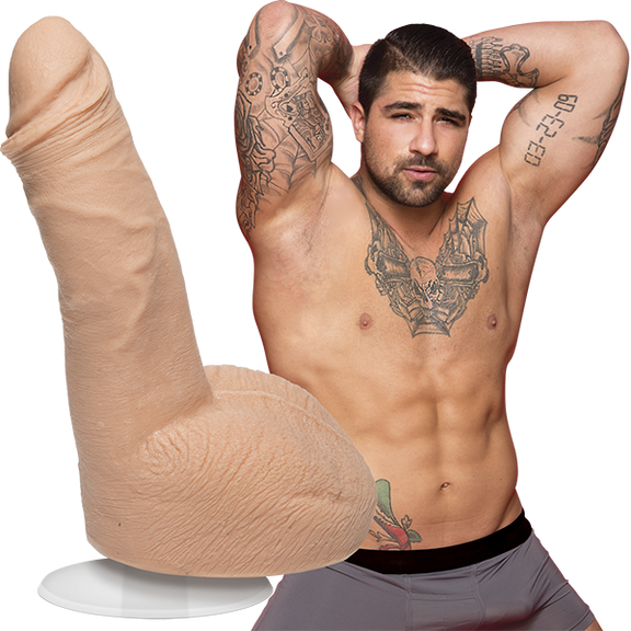 A shirtless Ryan Bones looks into the camera while wearing boxer briefs. The Signature Cocks - Ryan Bones dildo lifecast from the porn star is shown next to the porn star. | Kinkly Shop