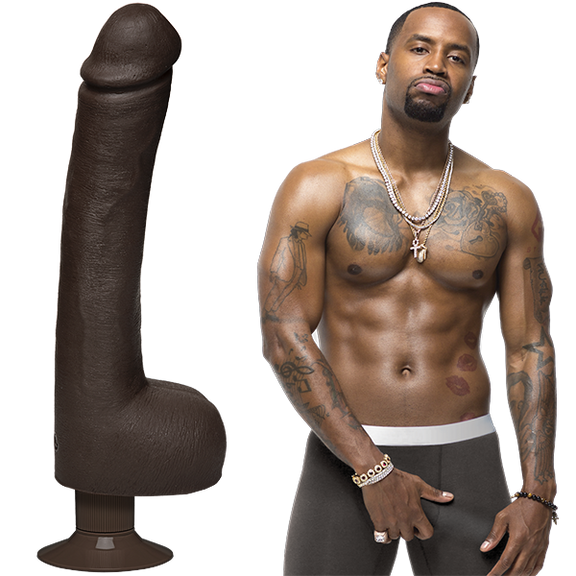 Safaree is shirtless and staring into the camera while grabbing his underwear bulge. The Signature Cocks - Safaree Ultraskyn Vibrating dildo is shown next to Safaree. | Kinkly Shop