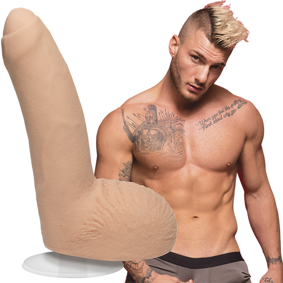 A shirtless William Seed looks into the camera. The Signature Cocks - William Seed dildo is shown next to the shirtless model. | Kinkly Shop