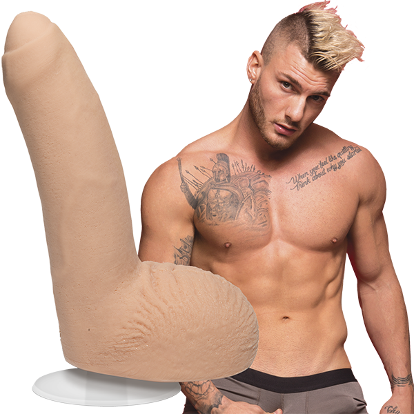 A shirtless William Seed looks into the camera. The Signature Cocks - William Seed dildo is shown next to the shirtless model. | Kinkly Shop