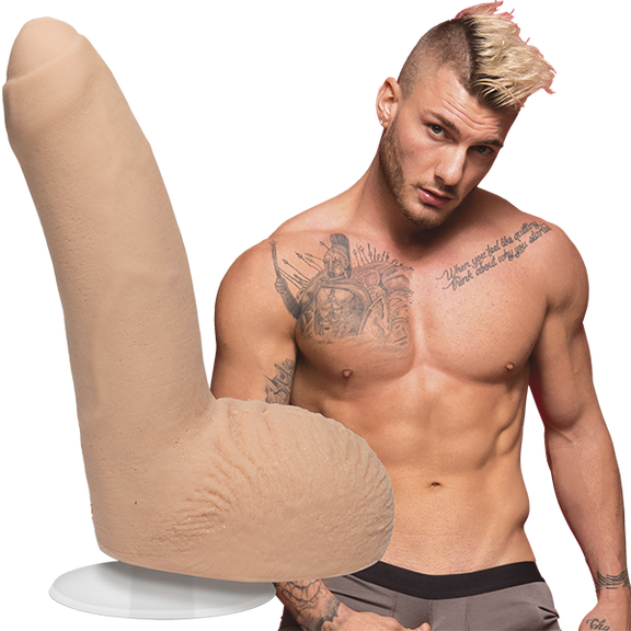 A shirtless William Seed looks into the camera. The Signature Cocks - William Seed dildo is shown next to the shirtless model. | Kinkly Shop