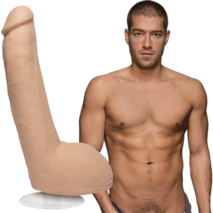 A naked Xander Corvus stares into the camera. The Signature Cocks - Xander Corvus dildo is shown next to Xander, which is modeled directly from the Xander's erect length. | Kinkly Shop