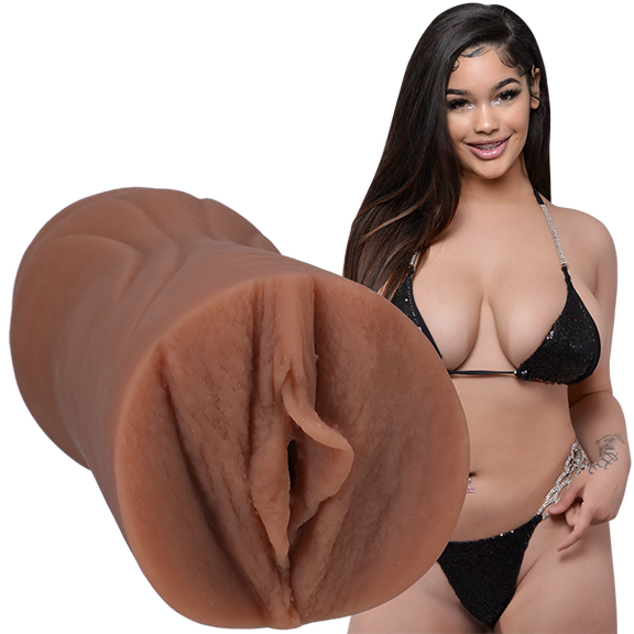 Lexi2Legit is wearing a black string bikini and looking into the camera. The Signature Strokers Lexi2legit stroker is shown next to the porn star. | Kinkly Shop