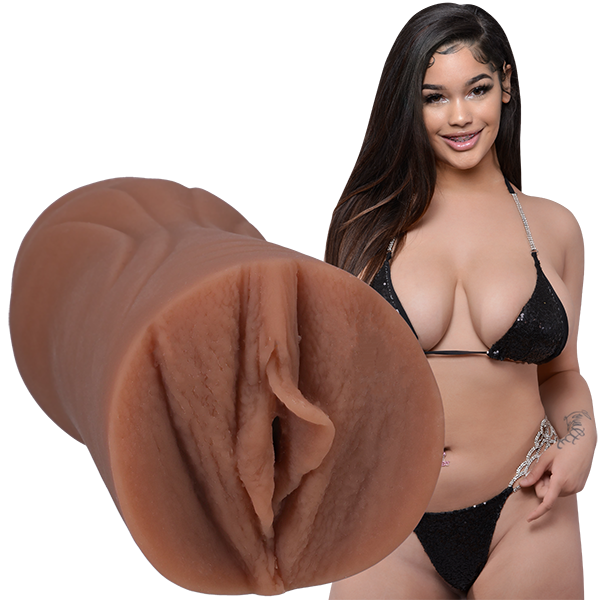 Lexi2Legit is wearing a black string bikini and looking into the camera. The Signature Strokers Lexi2legit stroker is shown next to the porn star. | Kinkly Shop