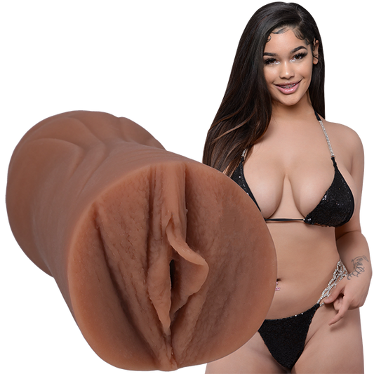 Lexi2Legit is wearing a black string bikini and looking into the camera. The Signature Strokers Lexi2legit stroker is shown next to the porn star. | Kinkly Shop