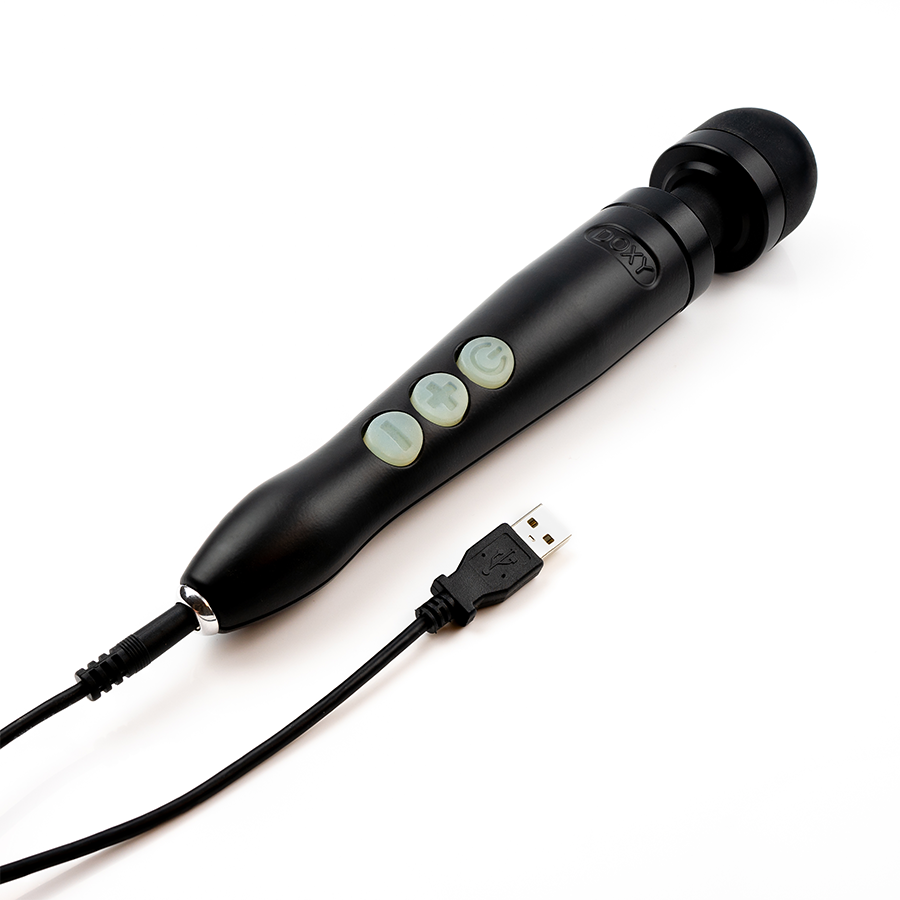 The Doxy Die Cast 3R shown plugged into its charger. It has a pin-style charger at the base. | Kinkly Shop