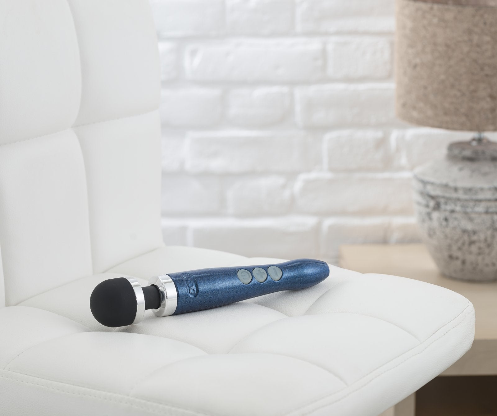 The Doxy Die Cast 3R resting on a chair. It looks extremely professional and modern. | Kinkly Shop