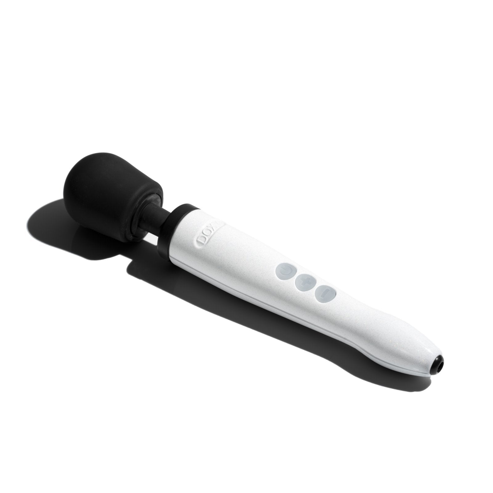 The Doxy Die Cast R lays in the sunlight, a harsh black shadow cast next to it from the strong rays. | Kinkly Shop