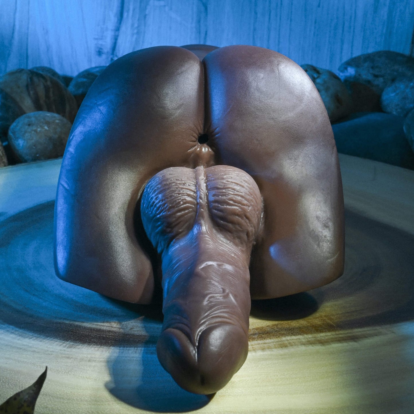 Close-up of the anal entrance of the Evolved Backdoor Bash in Espresso. The anal entrance is realistic-looking and textured with a pucker. The penis and testicles underneath the entrance also look very realistic. | Kinkly Shop