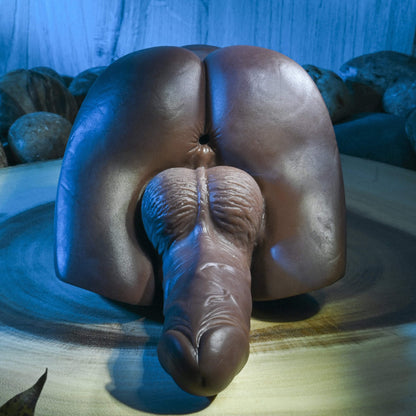 Close-up of the anal entrance of the Evolved Backdoor Bash in Espresso. The anal entrance is realistic-looking and textured with a pucker. The penis and testicles underneath the entrance also look very realistic. | Kinkly Shop
