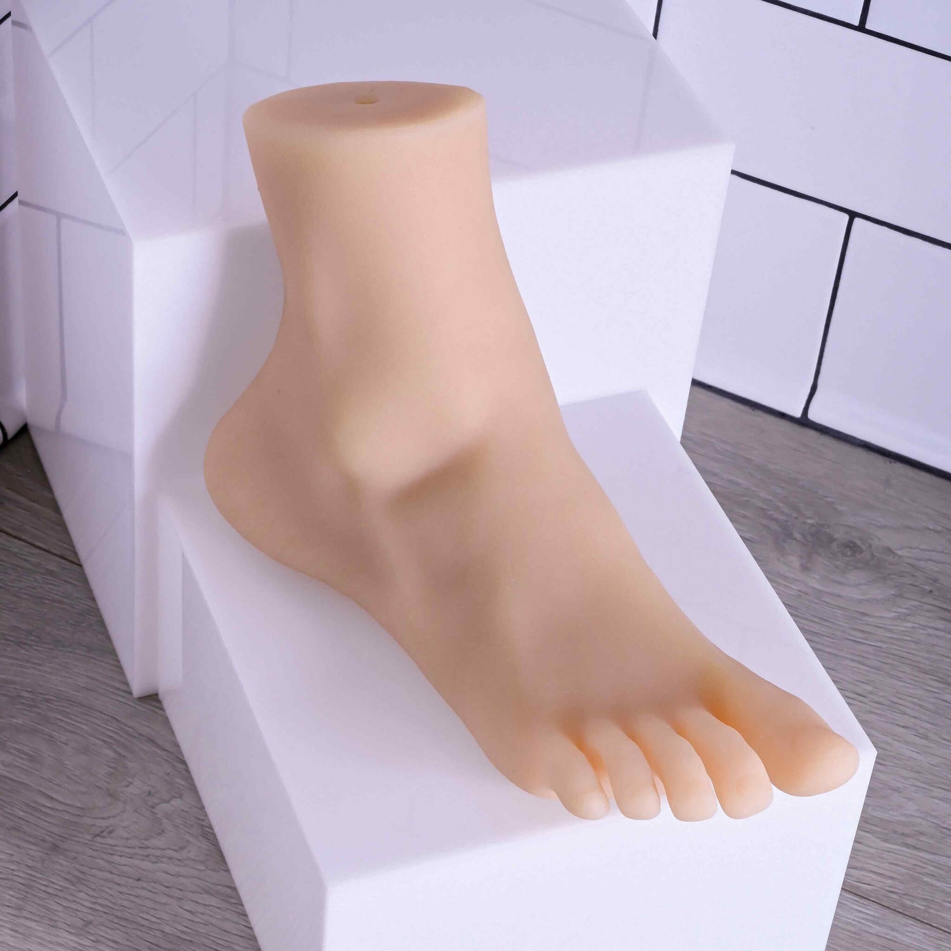 The Evolved Pussy Footin' sits out on an elevated riser. The "skin" of the stroker is very smooth and looks soft and plushy. | Kinkly Shop