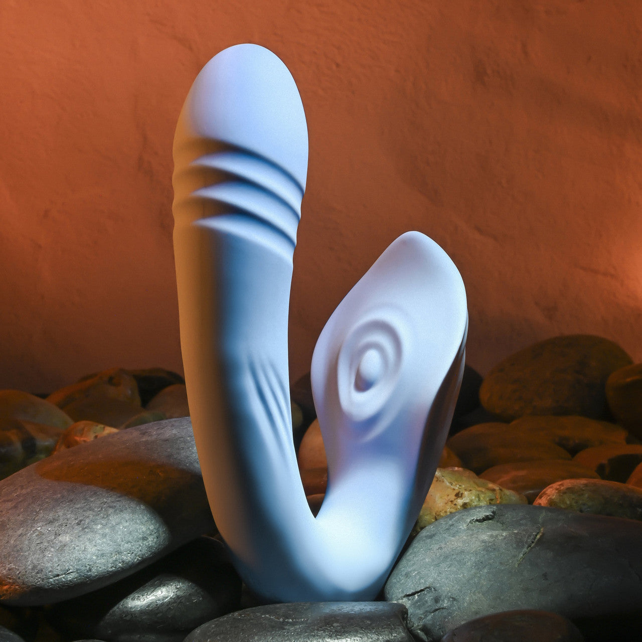 Shadowed view of the Evolved Tap & Thrust showcases the thrusting ribbing of the shaft as well as the tapping clitoral stimulator in the middle of a sting-ray-like winged arm | Kinkly Shop