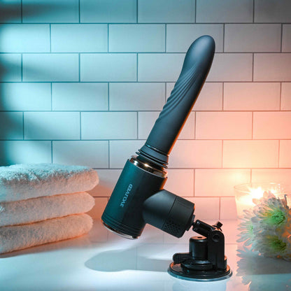 The Evolved Too Hot to Handle Thrusting Machine sitting out in front of a tiled background | Kinkly Shop