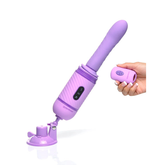 The Fantasy For Her Love Thrust Her is suction cupped to the ground beneath it. A hand is holding the remote, pointing it at the thruster toy. | Kinkly Shop