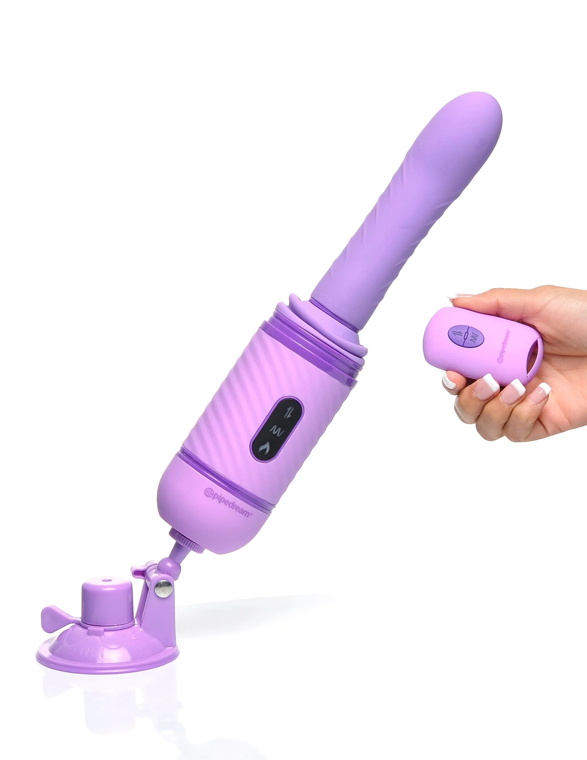 The Fantasy For Her Love Thrust Her is suction cupped to the ground beneath it. A hand is holding the remote, pointing it at the thruster toy. | Kinkly Shop