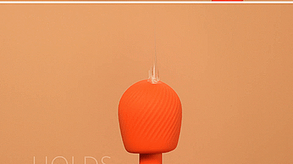 A GIF with a close-up on the head of the wand massager. A person drizzles lube messily onto the top of the wand massager. The text on the GIF reads "Holds lube" | Kinkly Shop