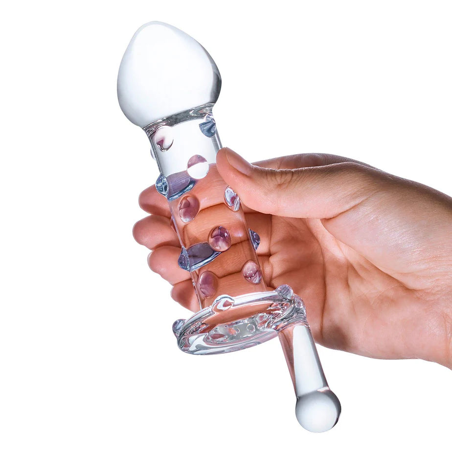 A hand holds the Glas Candy Land Juicer. The Juicer looks as long as a person's outstretched palm and thick enough to be about 3 or 4 fingers at the head. | Kinkly Shop
