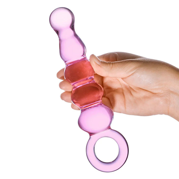 A hand holds the Glas Quintessence. The dildo looks decently thick in their hands but not overwhelmingly so. It looks about the size of an average penis. | Kinkly Shop