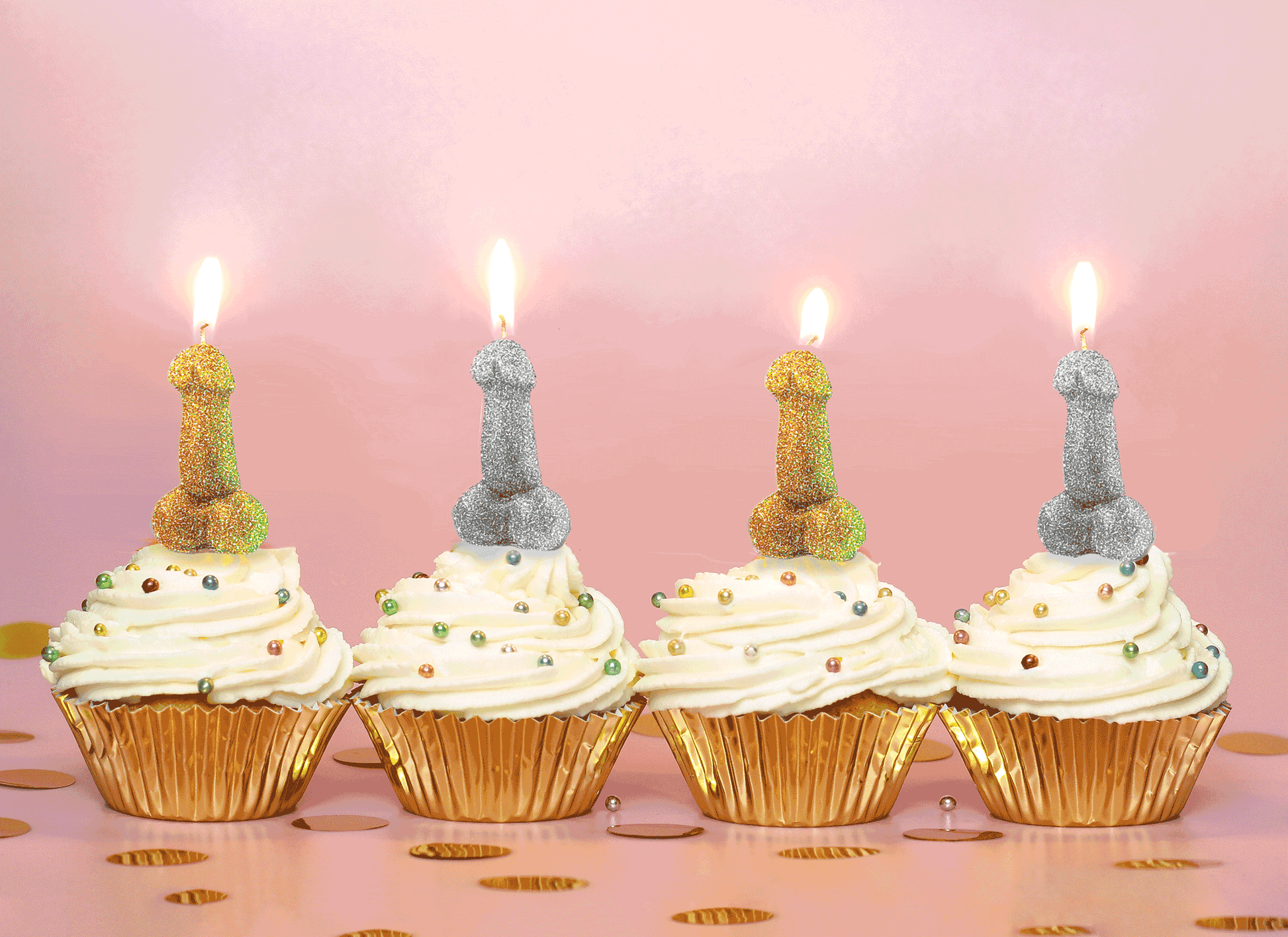 Four cupcakes in gold foil wrappers. Each cupcake has a lit Glitterati Penis Party Candle on top of it. | Kinkly Shop