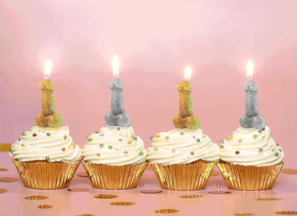 Four cupcakes in gold foil wrappers. Each cupcake has a lit Glitterati Penis Party Candle on top of it. | Kinkly Shop