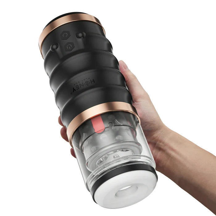 A hand holds the Honey Play Box Automatic Warrior. The stroker is much holder than a single hand, and it looks like it would need to be held with two hands. | Kinkly