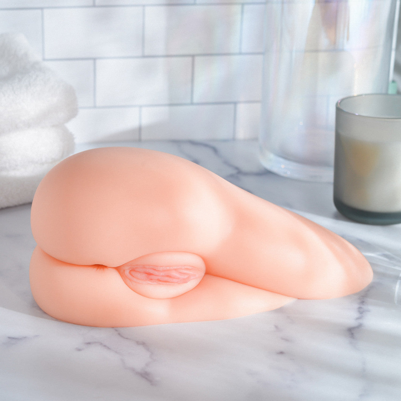The Kendra Spade Realistic Side Stroker is laying on its side, showcasing the unique lay-on-the-hip design. The vulva is very visible. | Kinkly Shop