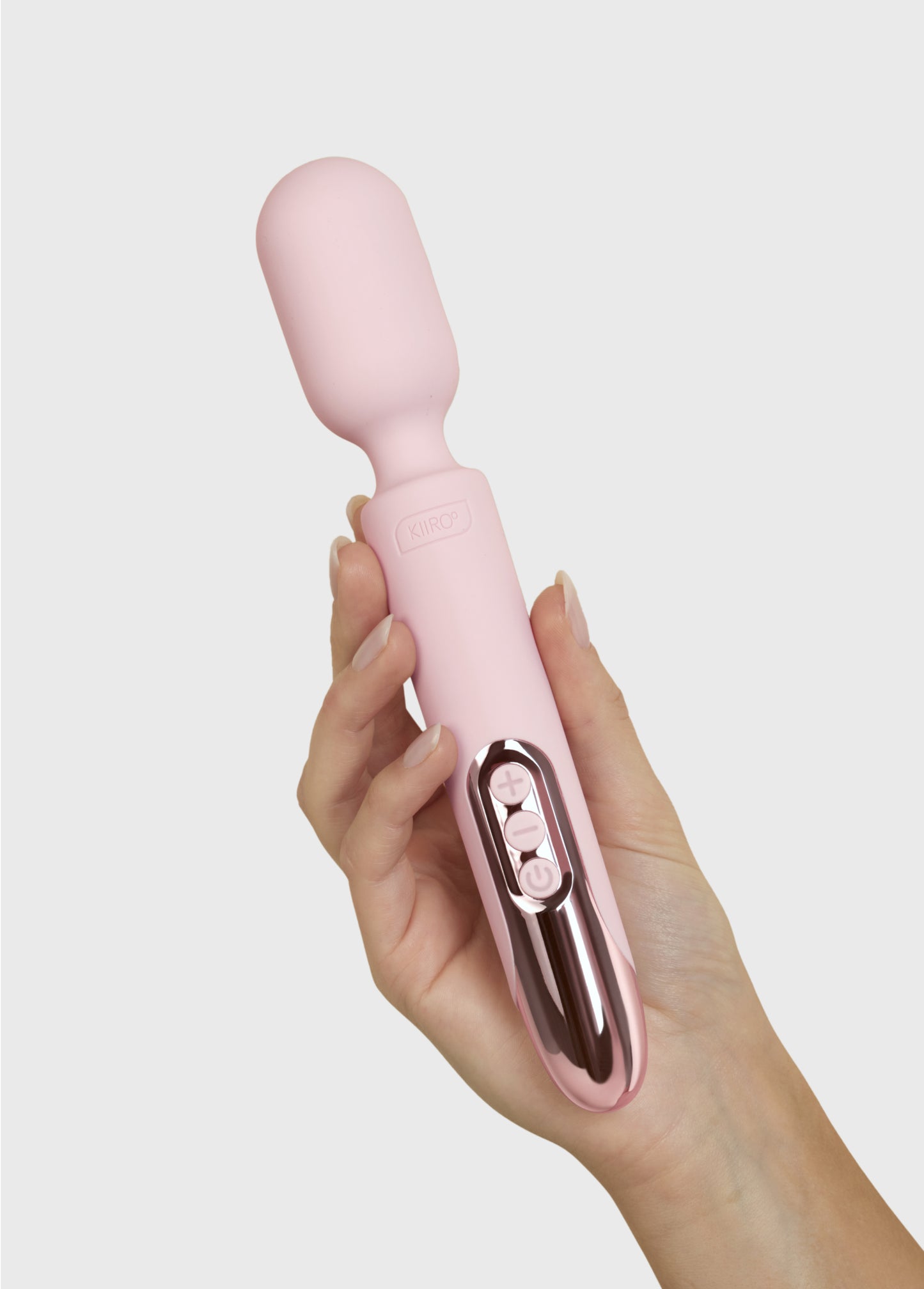 A hand holds the KIIROO ProWand. The wand's handle fits comfortably in their hand, and the head looks thin and long. | Kinkly Shop