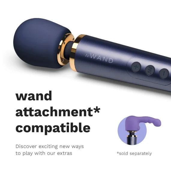 Close-up of the head of the Le Wand Petite Rechargeable shows an optional, not-included wand massager attachment on the top of the wand. Text reads: "wand attachment compatible. Discover new exciting ways to play with our extras." Kinkly Shop