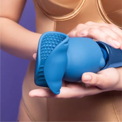 Le Wand Stroke Attachment shown on top of a wand massager. The textured nodules and ribbed interior are easily visible in the bright light. | Kinkly Shop