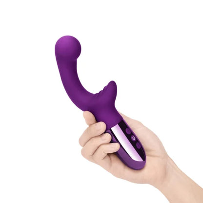 A hand is holding the Le Wand XO. The handle fits comfortably into a person's palm. | Kinkly Shop