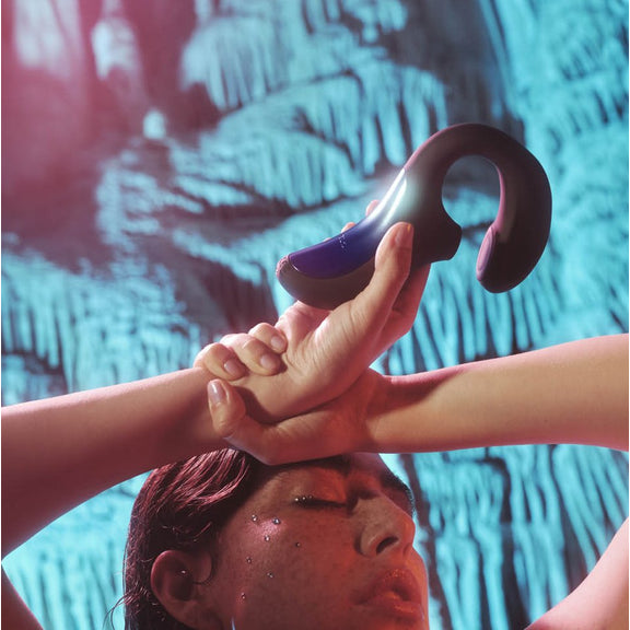 A person holds the LELO Enigma Double Sonic over their head. The vibrator's insertable portion looks particularly filling. | Kinkly Shop