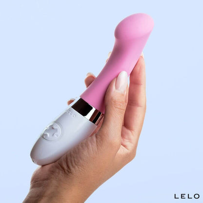 A hand cradles the LELO GIGI 2 against a white, well-lit background. The vibrator looks about the thickness of two fingers, and it is about the same length as the person's full outstretched palm and fingers. | Kinkly Shop
