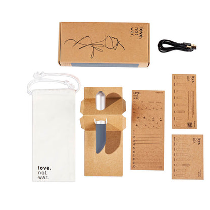 Everything that comes with the Love Not War Amore. The packaging is cardboard-focused with everything, including the instructions, in cardboard. The Love Not War Amore also comes with a cotton drawstring bag and a charging cable. | Kinkly Shop