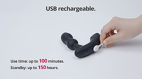 GIF shows a magnetic charging cord attached to the base of the Lovense Edge 2. Text on the GIF reads "USB Rechargeable. Use time up to 100 minutes. Standby up to 150 hours." | Kinkly Shop